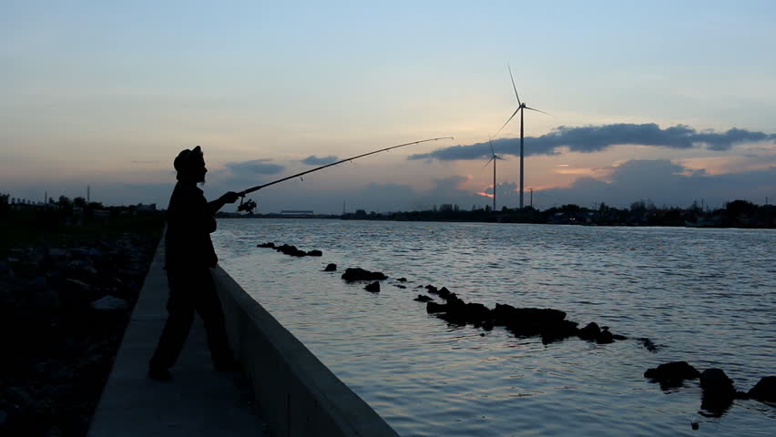 Fishermen Sunset on wind turbine background
