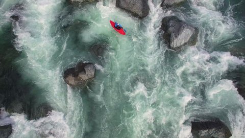 Overhead Aerial Shot of Man in Kayak on Raging River with Rapids