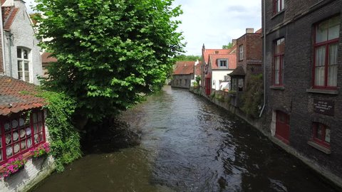 WIDE FIXED Establishing shot of water canal in Bruges, "Venice of the North", cityscape of Flanders, Belgium