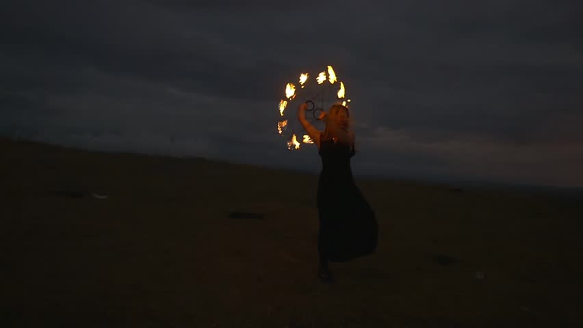 Woman with burning torches at the top of the mountain above the city at night. Actor does a fire performance outdoor on the top of the hill Royalty-Free Stock Footage #19691206