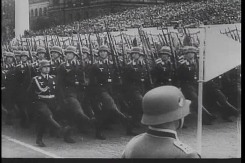 Walter Kronkite narrates a montage of global evil in the 1930s, covering Nazism, Japan's invasion of China, and Mussolini's invasion of Ethiopia. (TheB)