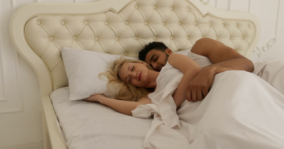 couple sleep lying on bed man hug woman home white modern bedroom slow motion