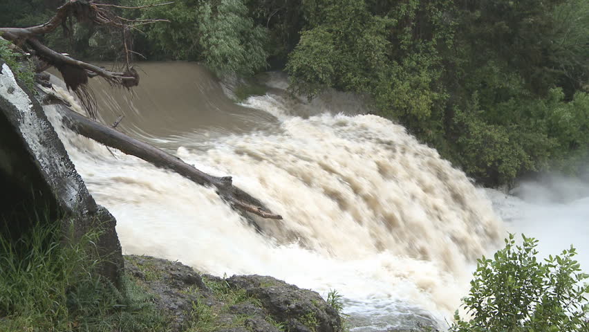 Flood waters pass over a waterfall