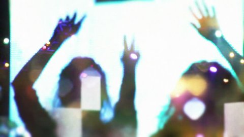 silhouettes concert dancing jumping waving,Stage and audience,girl at a concert seating on shoulders raising her hands,Lot of people clapping at rave party,summer festival people crowd partying night Stock Video
