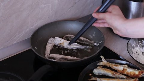 Woman Cooking a Smelt Fish