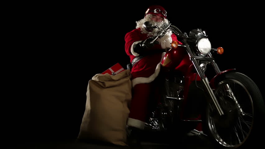 Santa Claus portrait on his red motorbike  slow motion