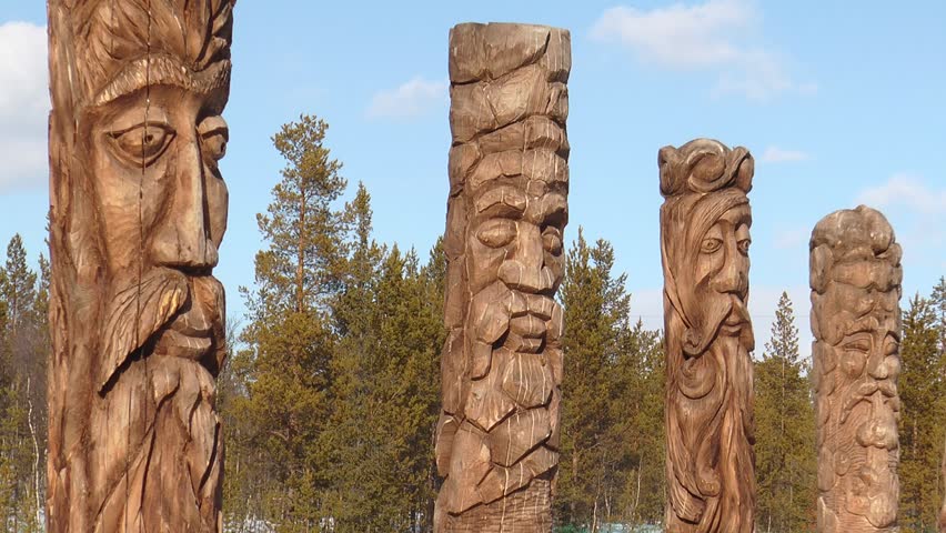 Lovozero, Russia.Several Sami idols standing in the woods a Sunny spring day.
