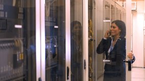 Technician talking on mobile phone while working in server room 4k - Powered by Shutterstock - Get 15% off with code: PIKWIZARD15