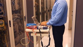 Technician talking on head phones while working laptop in server room 4k - Powered by Shutterstock - Get 15% off with code: PIKWIZARD15