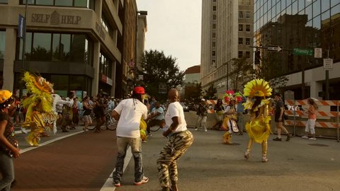 GREENSBORO, NC  -- SEPT 10, 2016 The colorful Bahamas Junkeroo Revue parade through the streets of Greensboro, NC at the National Folk Festival -- followed by dancing festival participants.