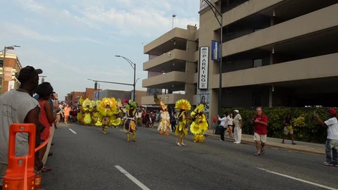 GREENSBORO, NC  -- SEPT 10, 2016 The colorful Bahamas Junkeroo Revue parade through the streets of Greensboro, NC at the National Folk Festival -- followed by dancing festival participants.