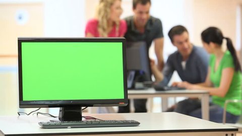 Green desktop screen set in front of workgroup