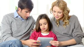 Family at home using electronic tablet