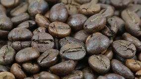 Close up of coffee beans. Loop rotation. Front of the camera rotates plate with coffee beans
