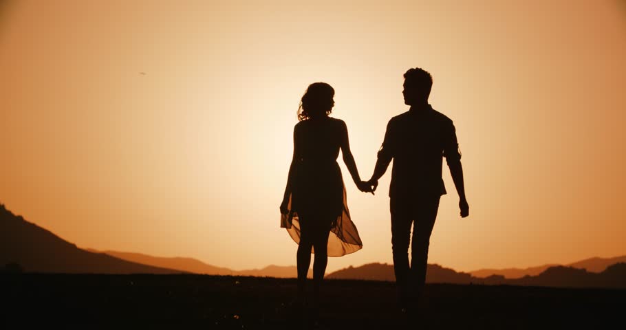 Couple Silhouette Walking In The Highlands Holding Hands With The Sunset Golden Hour The Sun A Warm Color Slow Motion