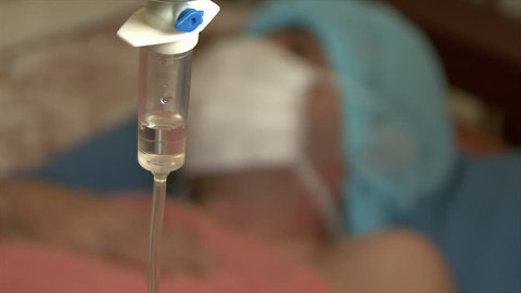 I.V. Intravenous saline drip with patient in the hospital room