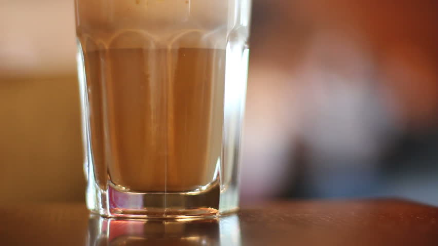 Glass of latte coffee in cafe