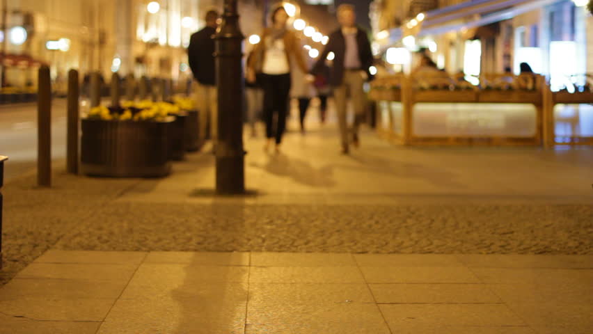 People stroll along sidewalk