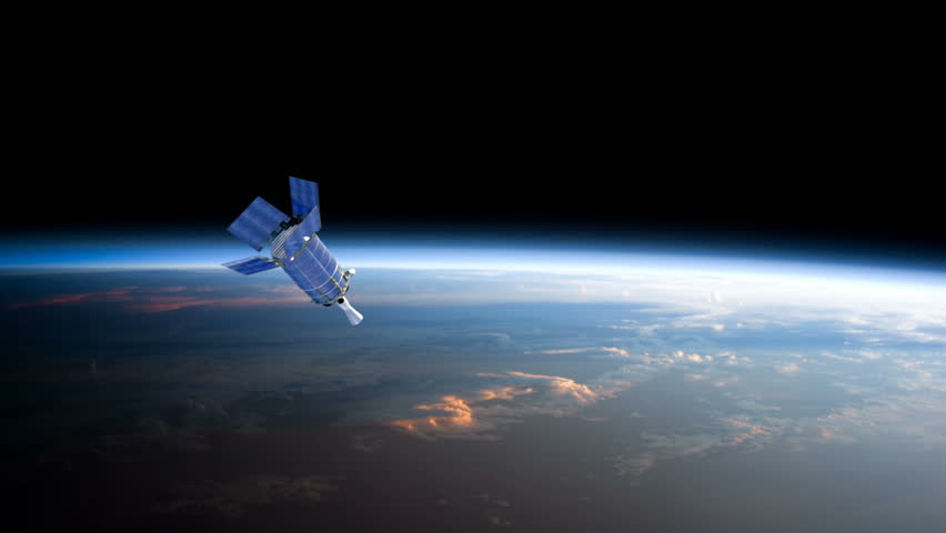 A Defense Support satellite high above the earth at sunset. 