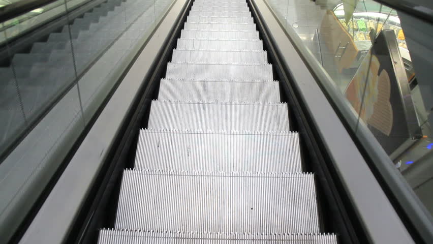 Going down empty escalator stairs