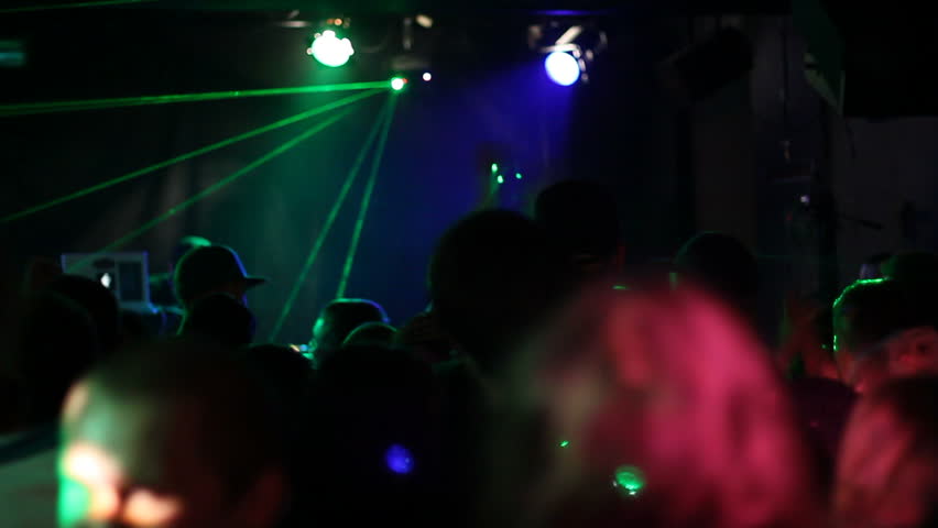 Laser lights and crowds at DJ show in club
