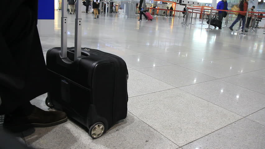 Black luggage case at an airport departure hall