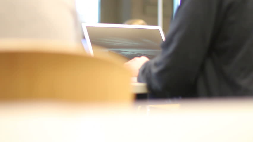 Students closes laptop in a library