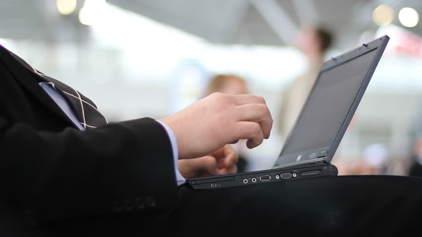 Businessman works on his laptop at the airport