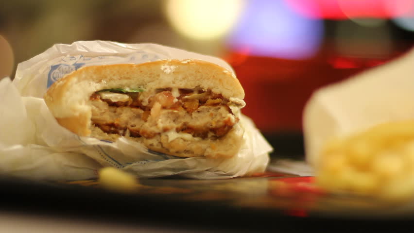 Half-eaten burger in fast-food restaurant