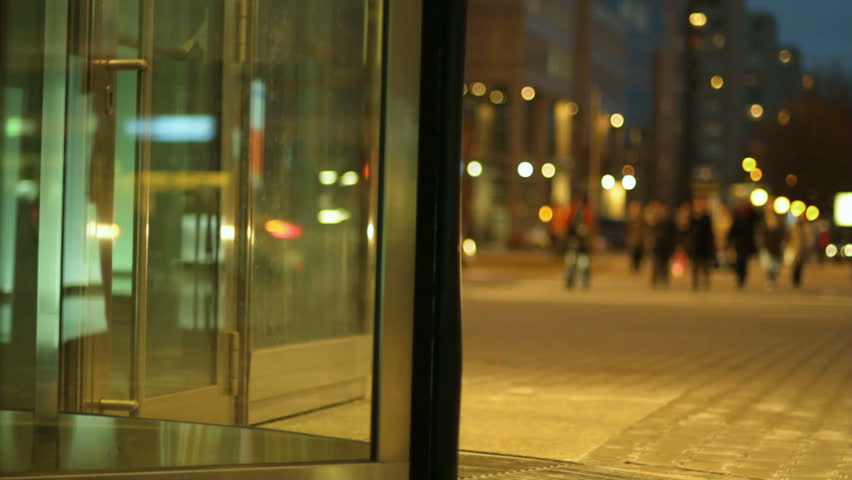 Glass revolving door and pedestrian on the street