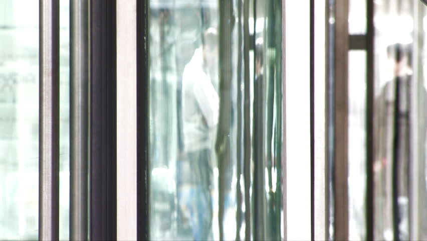 People silhouettes seen through glass door