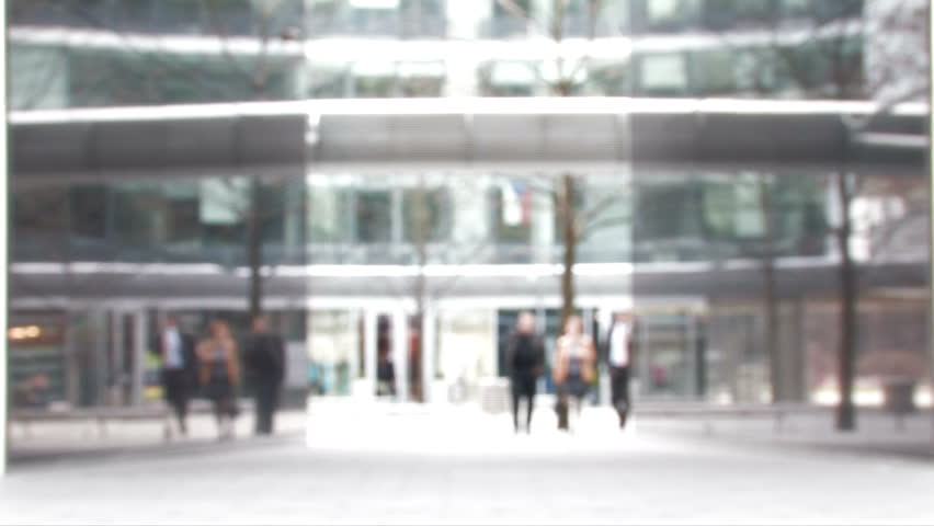 Business people walk towards camera-blurred