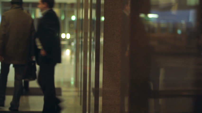 Businessman leaving office elevator _ blurred