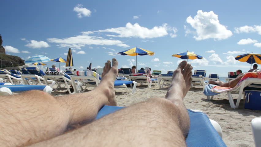 Male legs on beach chair