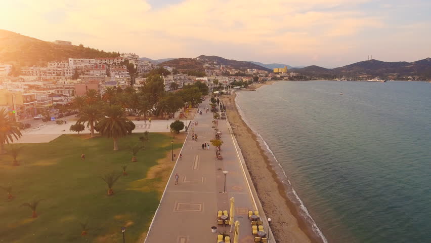 Aerial Flight Over Tourists Walking On Beach Walkway At Sunset Tourism Small Sea Town Exotic Mediterranean Beauty