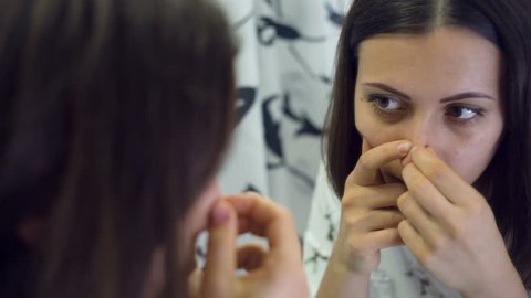 Woman squeezing pimples