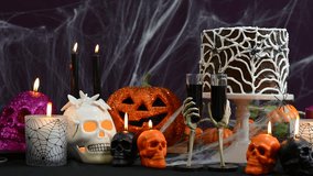 Spooky Halloween Party Table with chocolate spider cake and decorations, full table zooming in on cake. - Powered by Shutterstock - Get 15% off with code: PIKWIZARD15