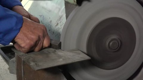 Hands of The Worker Sharpen Metal About Whetstone