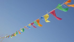 Slow motion colorful pennant banner crowd control rope against blue sky 1080p HD footage - On the wind wayving colorfoul flags as beach decoration slow-mo 1920X1080 FullHD video