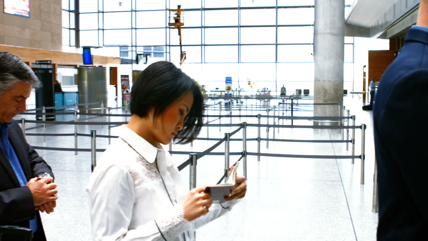 Commuters standing in queue for check-in at airport