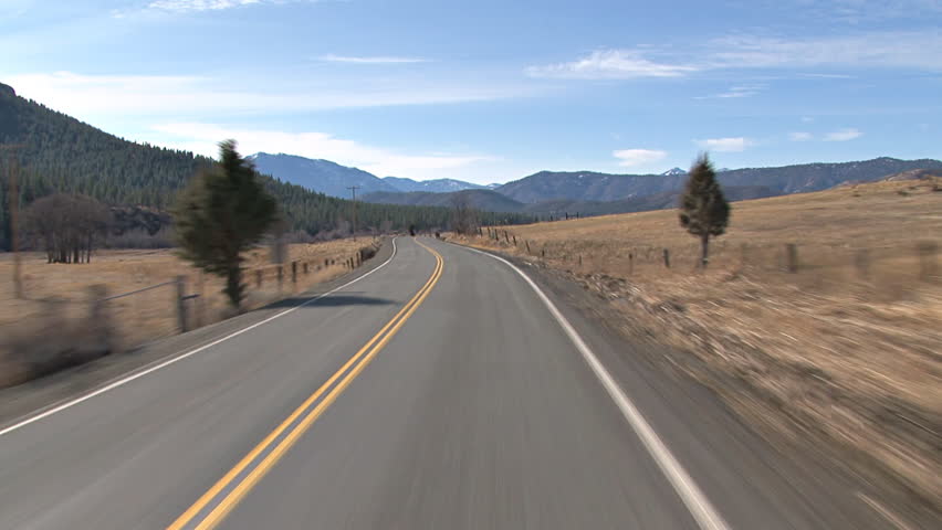 POV of driving west on country highway in Northern California