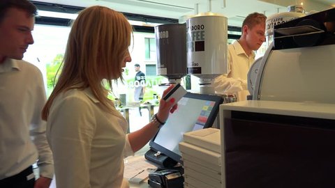 PRAGUE, CZECH REPUBLIC - JULY 2, 2016: waiters work on computer in restaurant - waiter bills order on computer