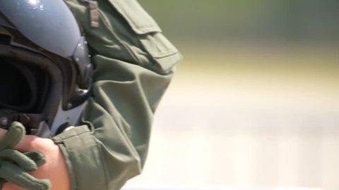Jet fighter helmet in the hands of a pilot