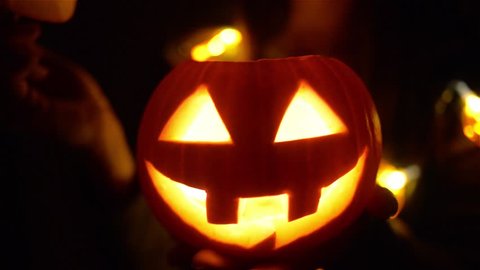 Halloween pumpkin with scary face with with a burning candle