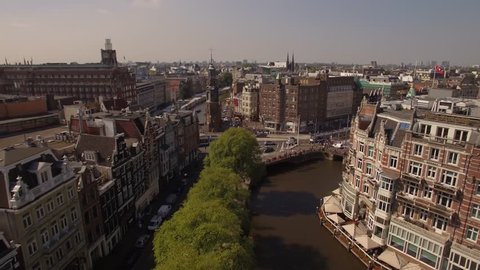 Amsterdam aerial sightseeing. Flying above old centre district. Netherlands in 4K.