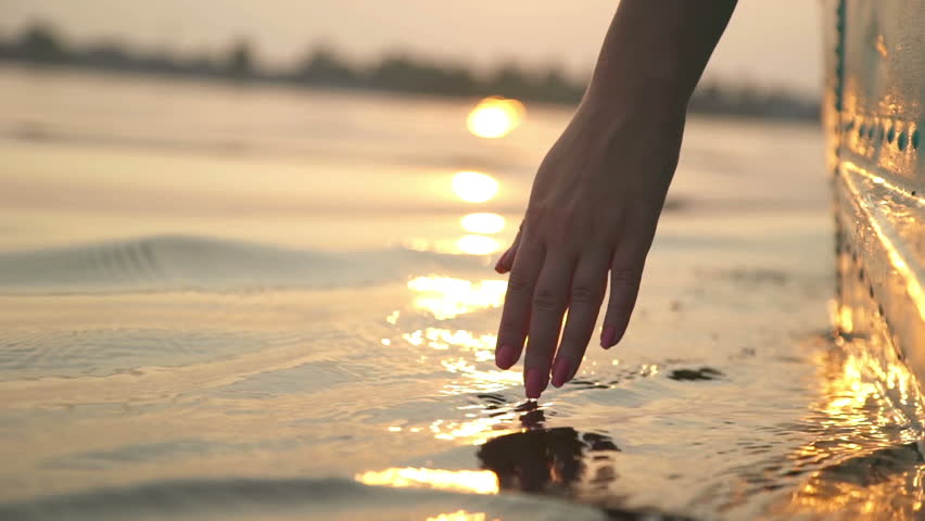 Close-up of girl's hand moving through the water Royalty-Free Stock Footage #19815016
