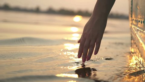 Close-up of girl's hand moving through the water