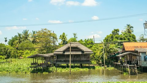 Time Lapse Shot of Thai-Style Abandon House at Riverside against the Blue Sky