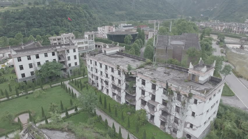 Aerial overview of a heavily damaged school building, a stark reminder of the disastrous earthquake that struck Sichuan province in China in 2008. D-log profile .