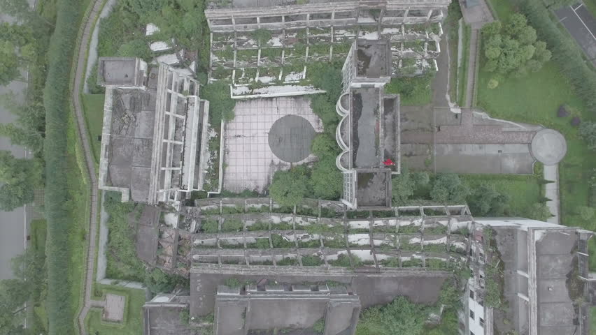 Aerial overview of a heavily damaged school building, a stark reminder of the disastrous earthquake that struck Sichuan province in China in 2008. D-log profile.